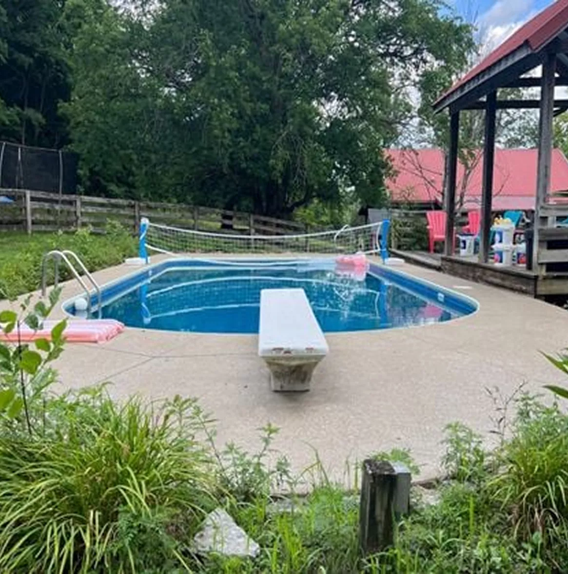Clean, level concrete deck surrounding an inground pool with uniform surface drainage.